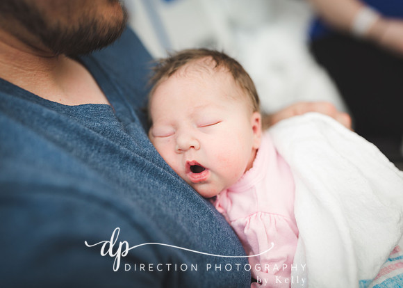 Newborn baby sleeping on her Dad's chest