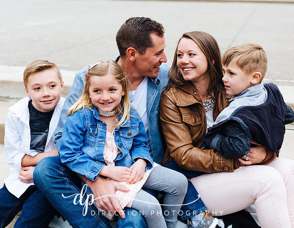 Attractive young family sitting on steps in front of Soldiers and Sailors Monument in Indianapolis IN