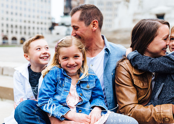Attractive young family sitting on steps in Indianapolis IN