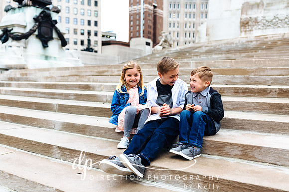 Attractive young family sitting on steps in Indianapolis IN