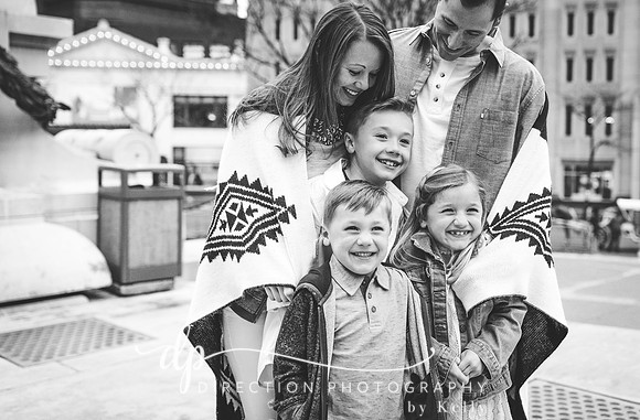 Attractive young family standing on steps in front of Soldiers and Sailors Monument in Indianapolis IN