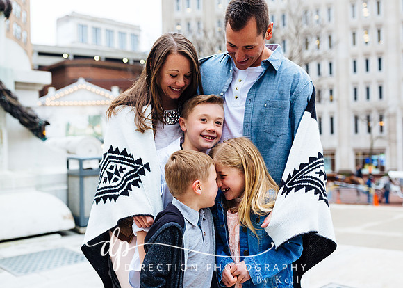 Attractive young family standing on steps in front of Soldiers and Sailors Monument in Indianapolis IN