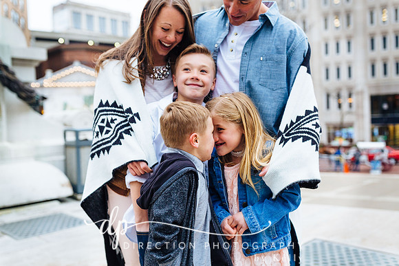 Attractive young family standing on steps in front of Soldiers and Sailors Monument in Indianapolis IN