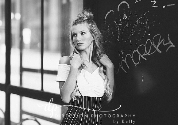 An attractive young woman posing for a senior portrait session in downtown Indianapolis IN